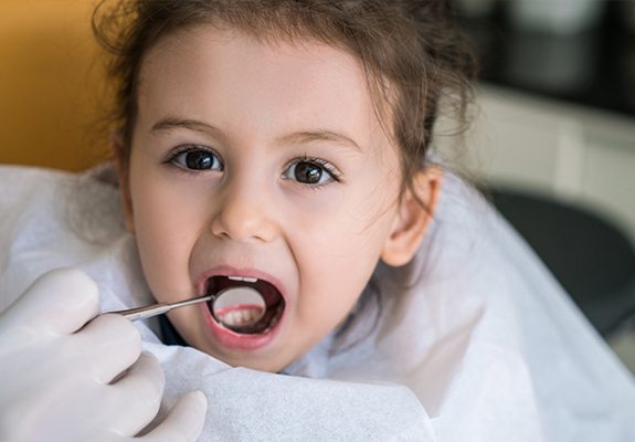 Little girl receiving dental treatment