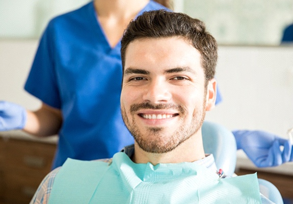 Smiling male patient at dentist’s